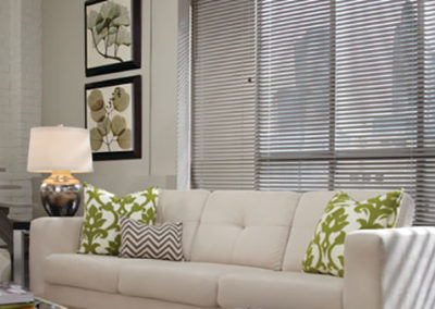 gray aluminum blinds on large living room windows