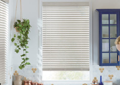 white faux wood blinds on kitchen windows