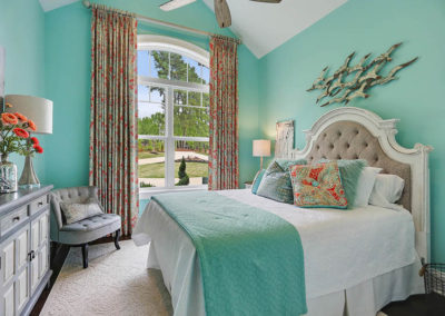 coral tan and teal floor to ceiling drapery in teal bedroom with white accents