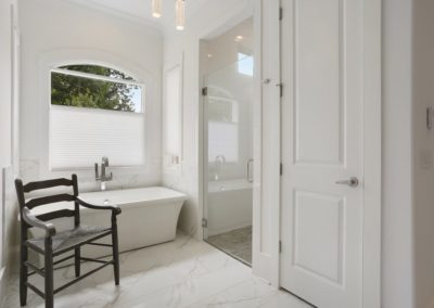 white honey comb shades top down bottom up on window above stand alone tub in bathroom