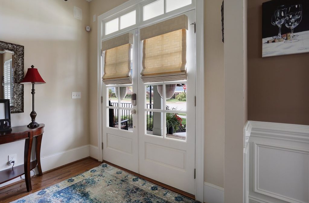 cream roman shades on front door