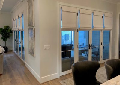 white woven shades on French doors in living room and kitchen doors and windows