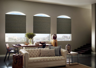 dark gray woven woods on large living room windows in apartment