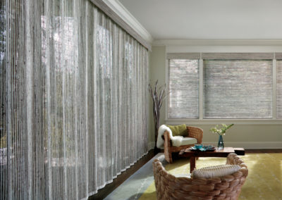 gray vertical and horizontal woven wood shades on large living room windows