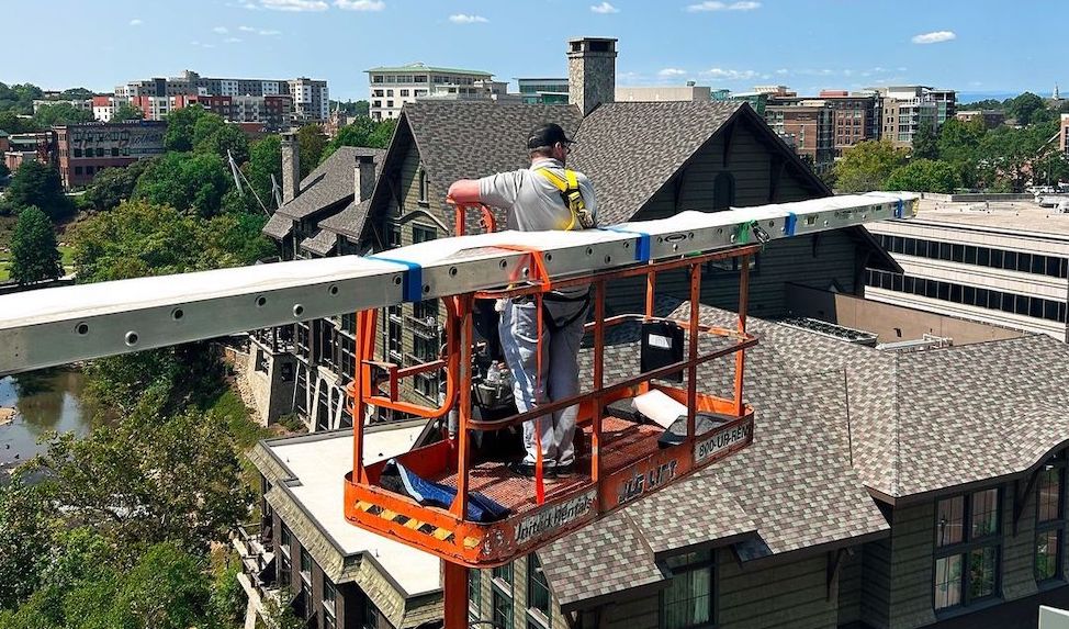 Integrity installer on boom lift with screen